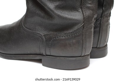 Back view of old military boots made of leather on white background, black army boots isolated on white, combat and ceremonial shoes of a soldier of the army of the Soviet Union