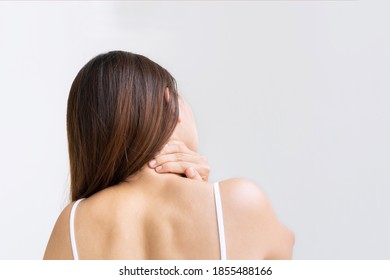 Back View Of Oung Asian Woman Suffering From Neck Pain Isolated On White Background, Studio Shot. Copy Space, Close Up