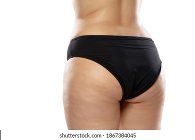 Back view. Overweight woman with fat cellulite legs and buttocks, obesity female body in black underwear isolated on white background. Orange peel skin, liposuction, healthcare and beauty treatment.