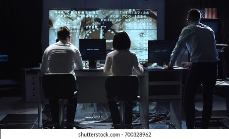 Back View Of People Working And Managing Flight In Mission Control Center. Docking To The International Space Station In Space. Elements Of This Image Furnished By NASA.