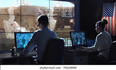 Back View Of People Working And Managing Flight In Mission Control Center. Elements Of This Image Furnished By NASA.