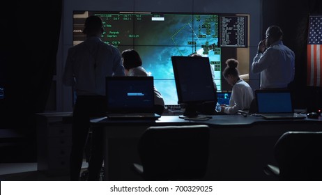 Back View Of People Working And Managing Flight In Mission Control Center. Elements Of This Image Furnished By NASA.