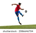 Back view photo of young soccer football player kicking a ball with his leg. Man training in uniform on grass flooring white background. Concept of action, team sport game, energy. Copy space for ad.