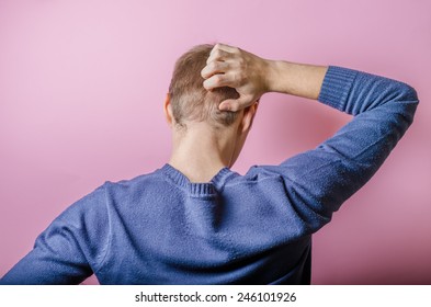 Back View Picture Of A Young Business Man Scratching His Head 