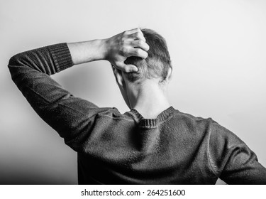 Back View Picture Of A Young Business Man Scratching His Head 