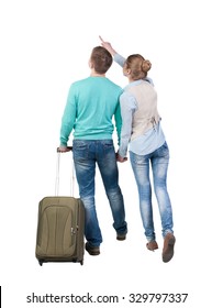 Back View Of Pointing Couple With  Green Suitcase Looking Up. Rear View People Collection.  Backside View Of Person.  Isolated Over White Background. 