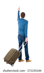 Back View Pointing Man With Suitcase. Brunette Guy Pointing. Backside View Person.  Rear View People Collection. Isolated Over White. Guy With Travel Bag On Wheels Looking At Something At Top