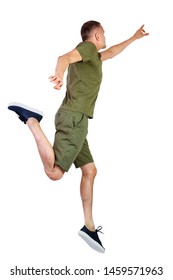 Back View Of Pointing Man In Zero Gravity Or A Fall. Guy Is Flying, Falling Or Floating In The Air.  Isolated Over White Background. The Guy In Shorts And Sneakers In A Jump Is Trying To Reach 