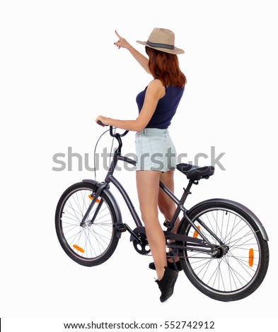 back view of pointing woman with bicycle. cyclist sits on bike. Rear view people collection. backside view person. Isolated over white background. Girl in a straw hat shows his hand forward with bike