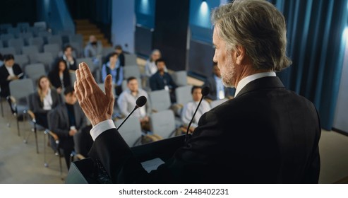 Back view of politician or activist pronouncing speech during press campaign in the conference hall. Mature organization representative answers questions, gives interview to journalists for media. - Powered by Shutterstock