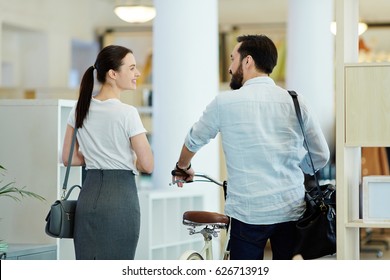 Back View Portrait Of Casual Asian Businessman Taking Bicycle To Work And Talking To Colleague Leaving Modern Creative Office