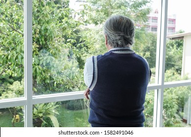 back view portrait of elderly Asian senior man with grey hair looking out window for thinking business seriously, business lifestyle concept - Powered by Shutterstock