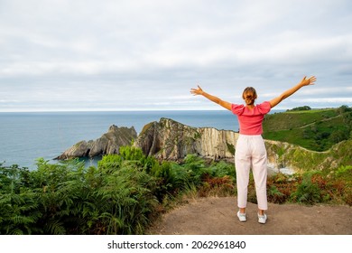 Back View Portrait Of An Excited Woman Celebrating Summer Vacation In A Coast