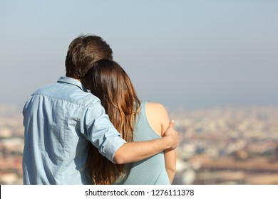 Back view portrait of a happy couple dating contemplating the city - Powered by Shutterstock