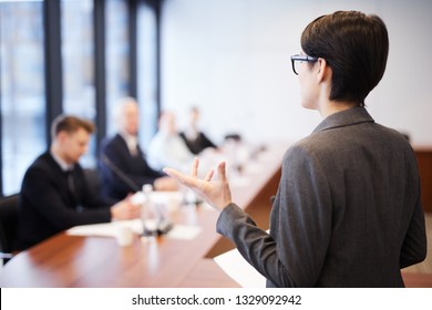 Back View Portrait Of Young Businesswoman Giving Speech In Conference Room And Gesturing, Copy Space