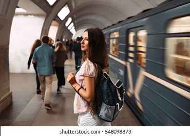 Back view portrait of young girl with backpack waiting the train in metro. - Shutterstock ID 548098873