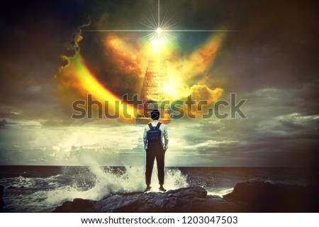 Back view portrait of young man standing against the sea with big wave beating with splash in a stair to heaven ,Conceptual of freedom life.