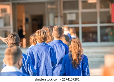 Back View Of Primary School Classmates On The First Day Of Lessons After Covid Pandemic.