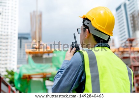 back view of professional engineer asian male safety helmet manage control constuction site with expertise working