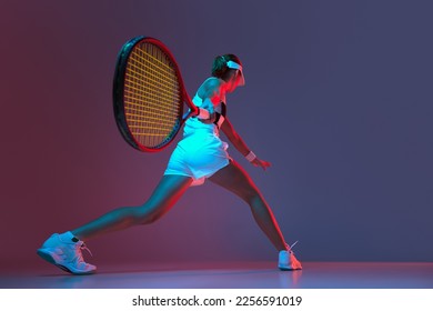 Back view of professional tennis player playing tennis over pink-purple background in neon light. Concept of sport, health, strength, action, motion, lifestyle. Copy space for ad - Powered by Shutterstock