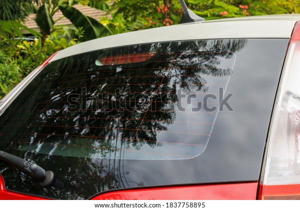 Back view of\
red car window for sticker\
mockup