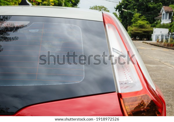 Back view of\
red car window for sticker\
mockup
