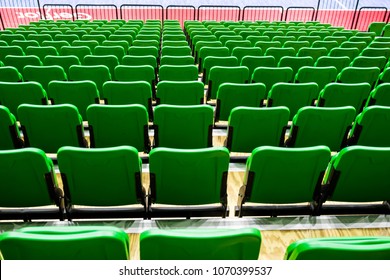 Back View Row Of Green Numbered Folding Seats Or Chair In Sports Complex Indoor Stadium Arena. Seating Area In Event Hall.