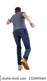 Back View Of Running  Man. Backside View Of Person.  Rear View People Collection. Isolated Over White Background. A Young Guy In Yellow Shoes Runs Ahead.