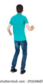 Back View Of Running Man In Brown Shirt. Walking Guy In Motion. Rear View People Collection. Backside View Person. Isolated Over White Background. The Guy In A Stylish Aquamarine Shirt Funny Dancing