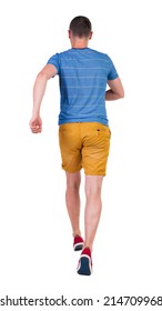 Back View Of Running Man In T-shirt And Shorts. Walking Guy In Motion. Rear View People Collection. Backside View Of Person. Isolated Over White Background.