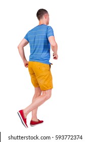 Back View Of Running Man In T-shirt And Shorts. Walking Guy In Motion. Rear View People Collection. Backside View Of Person. Isolated Over White Background.