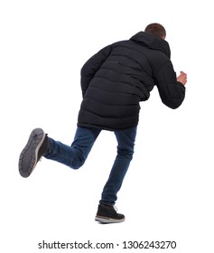 Back View Of A Running Man In Winter Jacket. Backside View Of Person.  Rear View People Collection. Isolated Over White Background. The Guy In The Winter Long Jacket Quickly Runs Past Crouching Low.