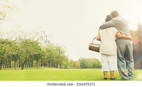 Back View Senior Couples Are Happy Charming Hugging In The Garden Showing Cute Moments Holding On To Each Other's Lasting Love Forever : Healthy Retired Senior Couple Standing Romantic In The Garden.