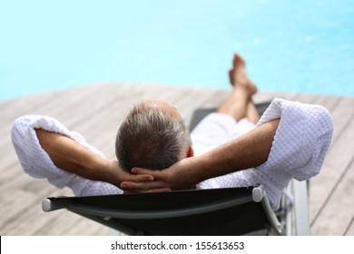 Back view of senior man reaxing in long chair - Powered by Shutterstock