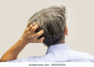 Back View Of Senior Man Scratching Head