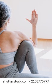 Back View Of The Senior Woman Practicing Yoga, Doing Half Lord Of The Fishes Exercise. Lady Sitting In Yoga Posture And Having Morning Meditation At Home. Physical And Spiritual Practice Concept