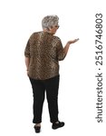 back view of a senior woman showing and looking at an imaginary object in her hand on white background.