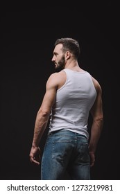 Back View Of Sexy Man Posing In White Singlet Isolated On Black