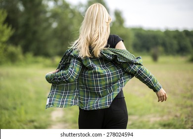 Back View Of Sexy Woman Taking Off Her Jacket.