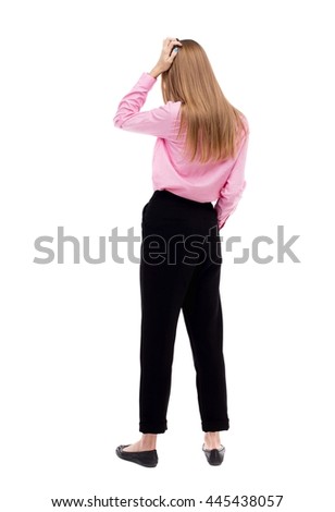 Back view of shocked woman. upset young girl. Rear view people collection.  backside view of person.  Isolated over white background. girl office worker in black pants is holding his head thoughtfully