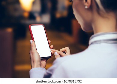 Back View From Shoulder Of Female Person Looking To Mock Up Copy Space Screen On Mobile Phone.Hipster Girl Using Blank Application On Smartphone Device.Close Up View, Texting Message In Social Network