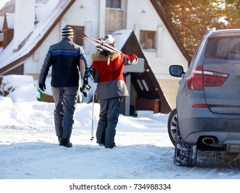 Back View Of Skiers Going Back To Hotel