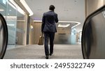 Back view of skilled business man phone calling to project manager while walking to meeting room. Caucasian project manager walking with meeting room with blurred background. Full body. Exultant.