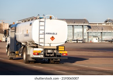 Back View Small Modern Fuel Tanker Truck Driving On Airfield Taxiway For Aircraft Refueling. Cistern Lorry Aviation Gasoline. Plane Gas Supply. Airport Maintenance Handling Service Vehicle Equipment