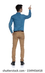 Back View Of Smart Casual Man In Blue Shirt Pointing Finger To Side, Standing Isolated On White Background, Full Body