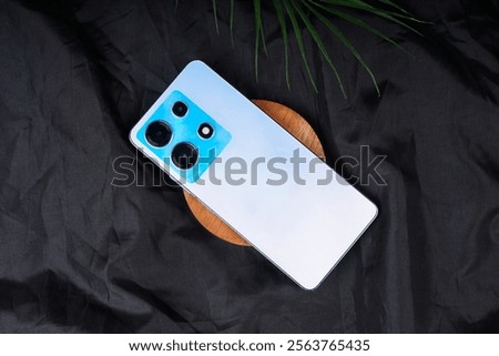 Back view of smartphone with quad camera on black background. High resolution photo.     