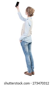 Back View Of Standing Young Beautiful  Woman And Using A Mobile Phone. Girl  Watching. Rear View People Collection.  Backside View Of Person.  Isolated Over White Background.