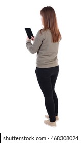 Back View Of Standing Young Beautiful  Woman  Using A Mobile Phone. Girl  Watching. Rear View People Collection.  Backside View Of Person.  Isolated Over White Background. A Girl In A Gray Sweater