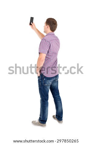 Back view of standing young men and using a mobile phone. Rear view people collection. Backside view of person. Isolated over white background