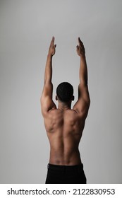 Back View Of Strong Athletic Black Man Shows Naked Muscular Body. Vertical.